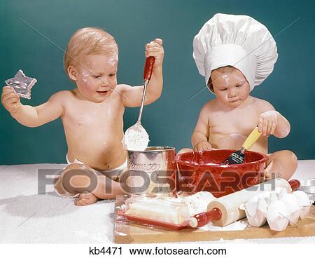 1960s TWO BABIES PLAYING BAKING IN KITCHEN View Large Photo Image Stock Image - 1960s TWO BABIES PLAYING BAKING IN KITCHEN. Fotosearch