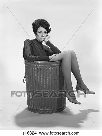 1960s UNHAPPY SAD DEPRESSED WOMAN IN TRASH CAN WEARING HIGH HEELS LOOKING AT CAMERA View Large Photo Image Picture - 1960s UNHAPPY SAD DEPRESSED WOMAN IN TRASH CAN WEARING HIGH HEELS LOOKING AT CAMERA. Fotosearch