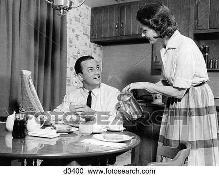 1960s WIFE POURING BREAKFAST COFFEE FOR HUSBAND DRINKING JUICE READING MORNING NEWSPAPER View Large Photo Image Stock Image - 1960s WIFE POURING BREAKFAST COFFEE FOR HUSBAND DRINKING JUICE READING MORNING NEWSPAPER. Fotosearch