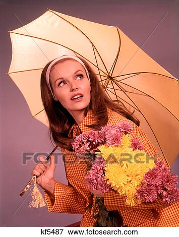 1960s WOMAN HOLDING UMBRELLA AND YELLOW AND PINK FLOWERS LOOKING TOWARD SKY View Large Photo Image Stock Photo - 1960s WOMAN HOLDING UMBRELLA AND YELLOW AND PINK FLOWERS LOOKING TOWARD SKY. Fotosearch