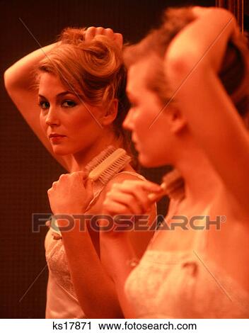 1970S 1980S Woman Wearing Slip Or Nightgown Brushing Hair Looking At Camera In Mirror Reflection View Large Photo Image Stock Image - 1970S 1980S Woman Wearing Slip Or Nightgown Brushing Hair Looking At Camera In Mirror Reflection. Fotosearch