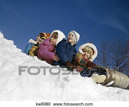 1970S 5 Boys Girls Together On Toboggan Smiling About To Slide In Snow View Large Photo Image Stock Image - 1970S 5 Boys Girls Together On Toboggan Smiling About To Slide In Snow . Fotosearch