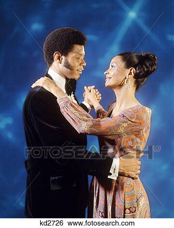 1970s AFRICAN AMERICAN COUPLE IN EVENING DRESS SLOW DANCING TOGETHER View Large Photo Image Stock Photograph - 1970s AFRICAN AMERICAN COUPLE IN EVENING DRESS SLOW DANCING TOGETHER. Fotosearch