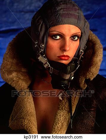 1970S Attractive Woman Aviator Pilot Looking At Camera With Serious Expression Wearing Fur Lined Flight Jacket And Helmet View Large Photo Image Stock Image - 1970S Attractive Woman Aviator Pilot Looking At Camera With Serious Expression Wearing Fur Lined Flight Jacket And Helmet. Fotosearch