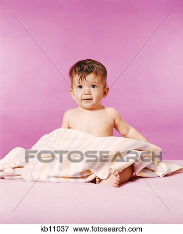 1970s BRUNETTE HAPPY BABY SITTING WITH BLANKET LOOKING AT CAMERA View Large Photo Image Stock Photo - 1970s BRUNETTE HAPPY BABY SITTING WITH BLANKET LOOKING AT CAMERA. Fotosearch