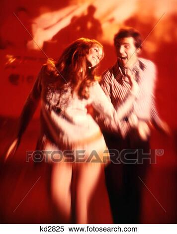 1970S Couple Man Woman Disco Dancing In Red Flashing Lights View Large Photo Image Stock Photography - 1970S Couple Man Woman Disco Dancing In Red Flashing Lights. Fotosearch