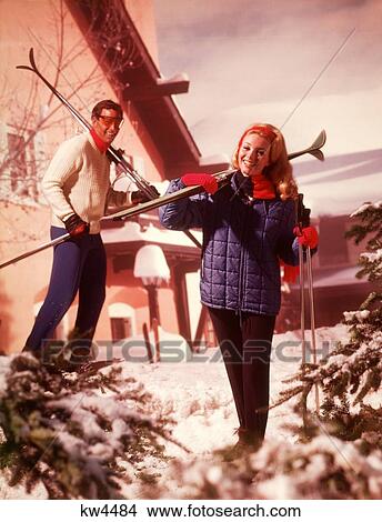 1970S Couple Man Woman Holding Skis Ski Poles Ski Chalet Lodge Snow Pine Trees Clothes Fashion Lifestyle View Large Photo Image Picture - 1970S Couple Man Woman Holding Skis Ski Poles Ski Chalet Lodge Snow Pine Trees Clothes Fashion Lifestyle. Fotosearch