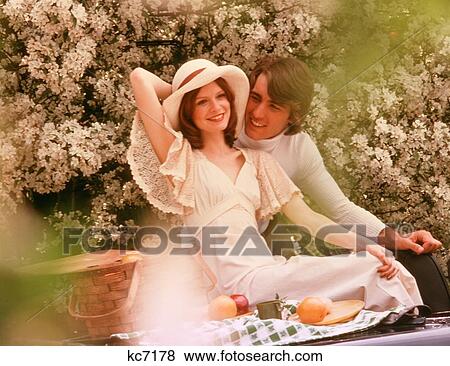 1970S Couple Man Woman Outdoors Spring Summer Blossoms Picnic Romantic Clothes Fashion View Large Photo Image Stock Photo - 1970S Couple Man Woman Outdoors Spring Summer Blossoms Picnic Romantic Clothes Fashion. Fotosearch