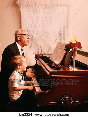 1970S Elderly Grandfather And Young Grandson Singing And Playing A Grand Piano Together View Large Photo Image Picture - 1970S Elderly Grandfather And Young Grandson Singing And Playing A Grand Piano Together. Fotosearch