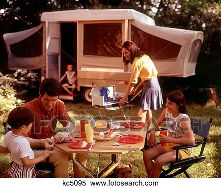 1970S Family Camping Vacation Campsite Mother Cooking On Camp Stove Father And Kids At Table Eating View Large Photo Image Stock Photography - 1970S Family Camping Vacation Campsite Mother Cooking On Camp Stove Father And Kids At Table Eating. Fotosearch