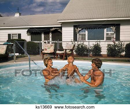 1970s FAMILY IN SUBURBAN BACKYARD SWIMMING POOL MAN WOMAN MOTHER FATHER PLAYING SPLASHING WITH LITTLE BOY SON View Large Photo Image Stock Photo - 1970s FAMILY IN SUBURBAN BACKYARD SWIMMING POOL MAN WOMAN MOTHER FATHER PLAYING SPLASHING WITH LITTLE BOY SON. Fotosearch