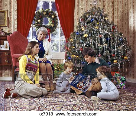1970s FAMILY READING CHRISTMAS BOOK MOTHER FATHER SONS GRANDMOTHER View Large Photo Image Stock Photo - 1970s FAMILY READING CHRISTMAS BOOK MOTHER FATHER SONS GRANDMOTHER. Fotosearch