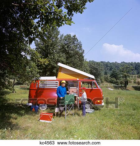 1970s FATHER AND SON COOKING AT CAMPSITE BESIDE RED POP TOP VW CARAVAN CAMPER View Large Photo Image Stock Image - 1970s FATHER AND SON COOKING AT CAMPSITE BESIDE RED POP TOP VW CARAVAN CAMPER. Fotosearch