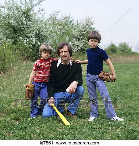 1970s FATHER AND TWO SONS WITH BASEBALL GLOVES AND BAT LOOKING AT CAMERA View Large Photo Image Stock Image - 1970s FATHER AND TWO SONS WITH BASEBALL GLOVES AND BAT LOOKING AT CAMERA. Fotosearch