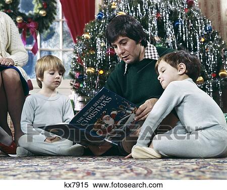 1970S Father Reading Night Before Christmas Story To 2 Boys By Tree Sitting On Floor View Large Photo Image Stock Photography - 1970S Father Reading Night Before Christmas Story To 2 Boys By Tree Sitting On Floor . Fotosearch