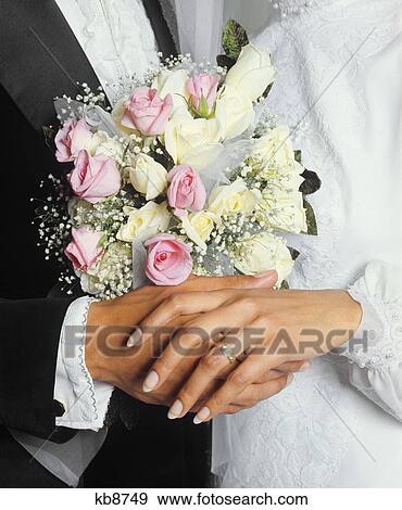 1970s HANDS OF AN ETHNIC BRIDE AND GROOM WITH FLOWER BOUQUET WEDDING RING View Large Photo Image Stock Photo - 1970s HANDS OF AN ETHNIC BRIDE AND GROOM WITH FLOWER BOUQUET WEDDING RING. Fotosearch