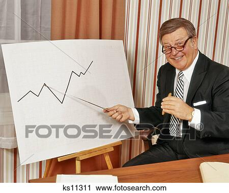 1970s HAPPY BUSINESSMAN LOOKING AT CAMERA POINTING TO GRAPH CHART INDICATING RISE IN BUSINESS SALES PROFITS View Large Photo Image Stock Image - 1970s HAPPY BUSINESSMAN LOOKING AT CAMERA POINTING TO GRAPH CHART INDICATING RISE IN BUSINESS SALES PROFITS. Fotosearch