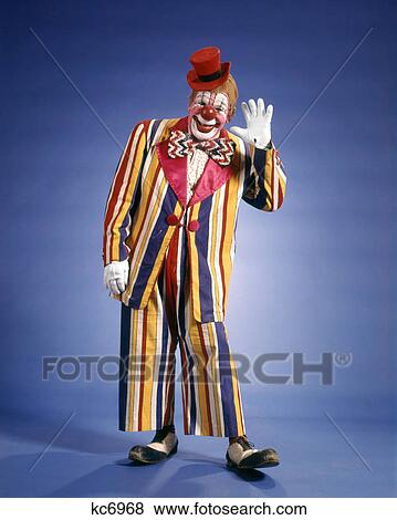 1970s HAPPY WAVING CIRCUS CLOWN STRIPED COLORFUL SUIT SMALL TOP HAT BIG BOW TIE FUNNY SHOES LOOKING AT CAMERA View Large Photo Image Stock Photo - 1970s HAPPY WAVING CIRCUS CLOWN STRIPED COLORFUL SUIT SMALL TOP HAT BIG BOW TIE FUNNY SHOES LOOKING AT CAMERA. Fotosearch