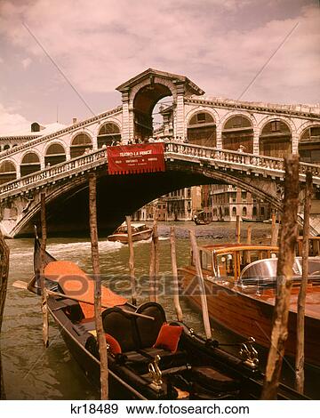 1970s ITALIAN VENETIAN GONDOLA WATER TAXI RIALTO BRIDGE GRAND CANAL VENICE ITALY View Large Photo Image Stock Photo - 1970s ITALIAN VENETIAN GONDOLA WATER TAXI RIALTO BRIDGE GRAND CANAL VENICE ITALY. Fotosearch