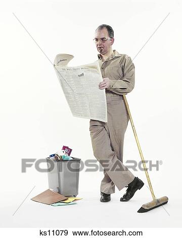 1970s JANITOR MAINTENANCE MAN LEANING ON BROOM SMOKING CIGAR READING WALL STREET JOURNAL NEWSPAPER BY OFFICE WASTEBASKET View Large Photo Image Stock Photo - 1970s JANITOR MAINTENANCE MAN LEANING ON BROOM SMOKING CIGAR READING WALL STREET JOURNAL NEWSPAPER BY OFFICE WASTEBASKET. Fotosearch