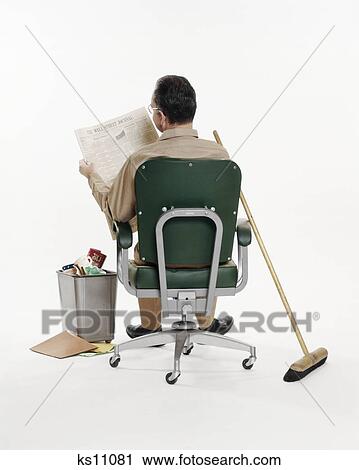 1970s JANITOR MAINTENANCE MAN SITTING IN OFFICE CHAIR READING WALL STREET JOURNAL NEWSPAPER BROOM WASTEBASKET REAR VIEW View Large Photo Image Stock Image - 1970s JANITOR MAINTENANCE MAN SITTING IN OFFICE CHAIR READING WALL STREET JOURNAL NEWSPAPER BROOM WASTEBASKET REAR VIEW. Fotosearch