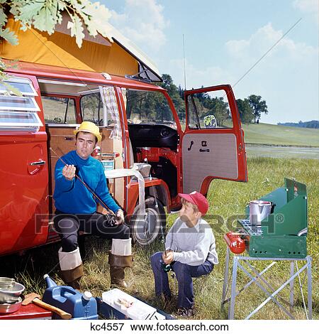 1970s MAN AND BOY CAMPING SON SITTING BY PORTABLE STOVE FATHER SITTING BY CAMPER WITH FISHING RODS AND GEAR View Large Photo Image Stock Photo - 1970s MAN AND BOY CAMPING SON SITTING BY PORTABLE STOVE FATHER SITTING BY CAMPER WITH FISHING RODS AND GEAR. Fotosearch