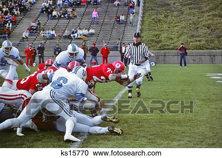 1970s PLAYER STRETCHING OVER GOAL LINE FOR TOUCHDOWN COLLEGIATE FOOTBALL GAME View Large Photo Image Stock Image - 1970s PLAYER STRETCHING OVER GOAL LINE FOR TOUCHDOWN COLLEGIATE FOOTBALL GAME. Fotosearch