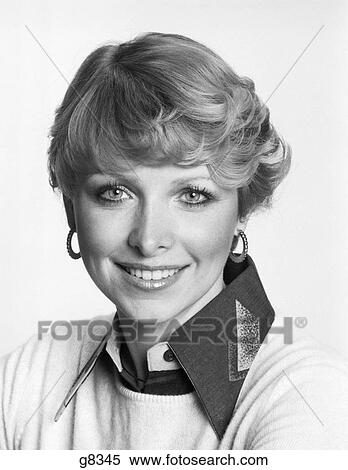 1970S Portrait Smiling Woman Looking At Camera Short Hair Blouse Large Collar Under Sweater View Large Photo Image Stock Photography - 1970S Portrait Smiling Woman Looking At Camera Short Hair Blouse Large Collar Under Sweater . Fotosearch