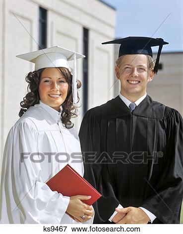 1970s PORTRAIT STUDENT COUPLE IN GRADUATION ROBES LOOKING AT CAMERA View Large Photo Image Stock Photo - 1970s PORTRAIT STUDENT COUPLE IN GRADUATION ROBES LOOKING AT CAMERA. Fotosearch
