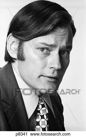 1970S Portrait Young Man Serious Facial Expression Sideburns Necktie Profile Looking At Camera View Large Photo Image Stock Image - 1970S Portrait Young Man Serious Facial Expression Sideburns Necktie Profile Looking At Camera . Fotosearch