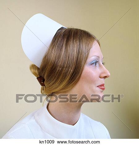 1970s PROFILE PORTRAIT REGISTERED NURSE WEARING CAP AND SLEEK HAIRSTYLE View Large Photo Image Stock Photo - 1970s PROFILE PORTRAIT REGISTERED NURSE WEARING CAP AND SLEEK HAIRSTYLE. Fotosearch