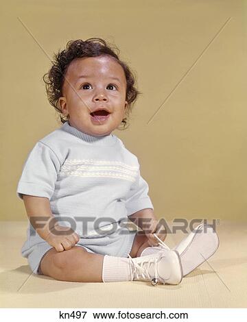 1970s SMILING CURLY HAIR AFRICAN AMERICAN BABY BOY SITTING HAPPY LOOKING UPWARD View Large Photo Image Stock Photo - 1970s SMILING CURLY HAIR AFRICAN AMERICAN BABY BOY SITTING HAPPY LOOKING UPWARD. Fotosearch