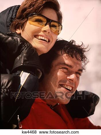 1970S Smiling Happy Portrait Man Woman Ski Couple Jackets Gloves Woman Wearing Yellow Goggles Glasses View Large Photo Image Stock Photo - 1970S Smiling Happy Portrait Man Woman Ski Couple Jackets Gloves Woman Wearing Yellow Goggles Glasses. Fotosearch