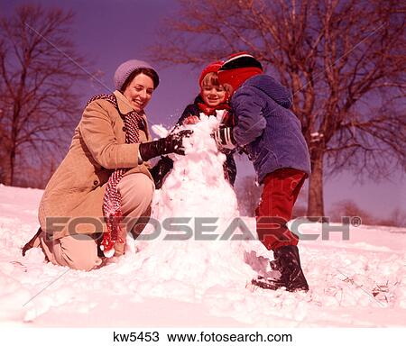 1970s SMILING WOMAN MOTHER TWO BOYS SONS BUILDING SNOWMAN TOGETHER View Large Photo Image Stock Image - 1970s SMILING WOMAN MOTHER TWO BOYS SONS BUILDING SNOWMAN TOGETHER. Fotosearch
