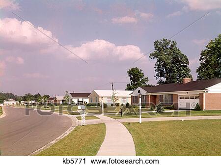 1970s SUBURBAN COMMUNITY RANCH STYLE HOUSES ALONG SIDEWALK AND STREET WITH MAILBOXES View Large Photo Image Stock Image - 1970s SUBURBAN COMMUNITY RANCH STYLE HOUSES ALONG SIDEWALK AND STREET WITH MAILBOXES. Fotosearch