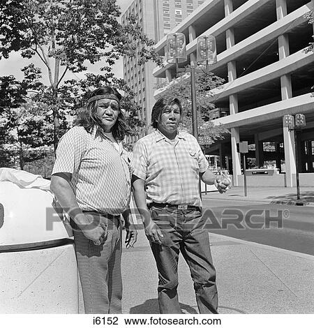 1970s TWO NATIVE AMERICAN CHIPPEWA INDIAN MEN BROTHERS LOOKING AT CAMERA STANDING BY CITY PARK MINNEAPOLIS MN USA View Large Photo Image Stock Image - 1970s TWO NATIVE AMERICAN CHIPPEWA INDIAN MEN BROTHERS LOOKING AT CAMERA STANDING BY CITY PARK MINNEAPOLIS MN USA. Fotosearch