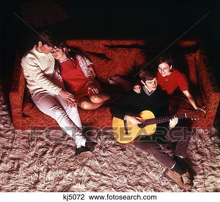 1970S Two Teenaged Couples In Recreation Or Living Room With Shag Rug One Couple Necking The Other With Acoustic Guitar View Large Photo Image Stock Image - 1970S Two Teenaged Couples In Recreation Or Living Room With Shag Rug One Couple Necking The Other With Acoustic Guitar. Fotosearch