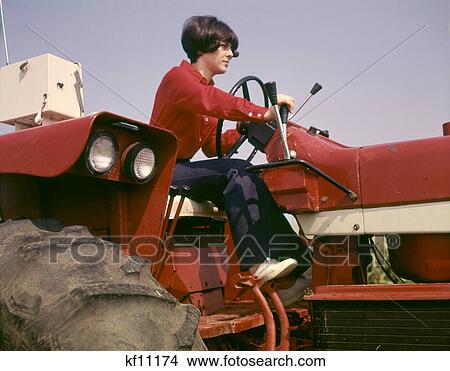 1970s WOMAN FARM WIFE DRIVING FARM TRACTOR TUSCOLA ILLINOIS USA View Large Photo Image Picture - 1970s WOMAN FARM WIFE DRIVING FARM TRACTOR TUSCOLA ILLINOIS USA. Fotosearch