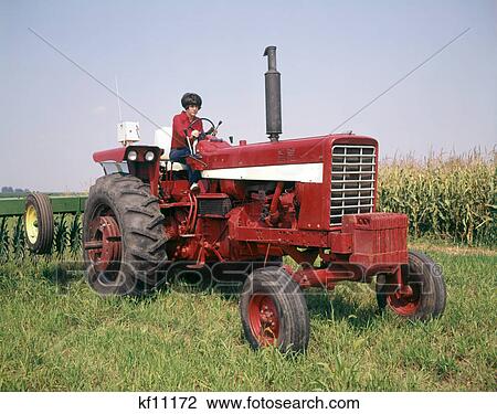 1970s WOMAN FARM WIFE DRIVING FARM TRACTOR PULLING HAY RAKE TUSCOLA ILLINOIS USA View Large Photo Image Stock Image - 1970s WOMAN FARM WIFE DRIVING FARM TRACTOR PULLING HAY RAKE TUSCOLA ILLINOIS USA. Fotosearch