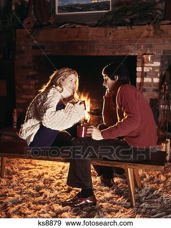 1970S Young Smiling Couple Sitting By Fireplace View Large Photo Image Stock Photo - 1970S Young Smiling Couple Sitting By Fireplace. Fotosearch
