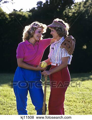 Stock Photo - 1980S 1990S Mother And Teen Daughter Ready To Play Baseball . Fotosearch