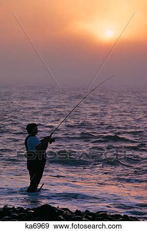 1980s ANONYMOUS SILHOUETTED MAN SURF FISHING View Large Photo Image Stock Photo - 1980s ANONYMOUS SILHOUETTED MAN SURF FISHING. Fotosearch