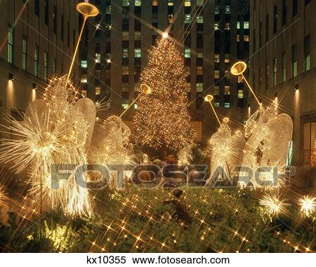 1980s ROCKEFELLER CENTER LIGHTED ANGELS AND CHRISTMAS TREE NEW YORK CITY NEW YORK USA View Large Photo Image Stock Photography - 1980s ROCKEFELLER CENTER LIGHTED ANGELS AND CHRISTMAS TREE NEW YORK CITY NEW YORK USA. Fotosearch