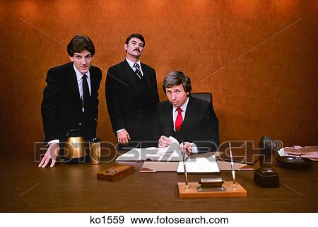 1980s THREE SHARP AGGRESSIVE BUSINESS EXECUTIVES LOOKING AT CAMERA View Large Photo Image Stock Photo - 1980s THREE SHARP AGGRESSIVE BUSINESS EXECUTIVES LOOKING AT CAMERA. Fotosearch