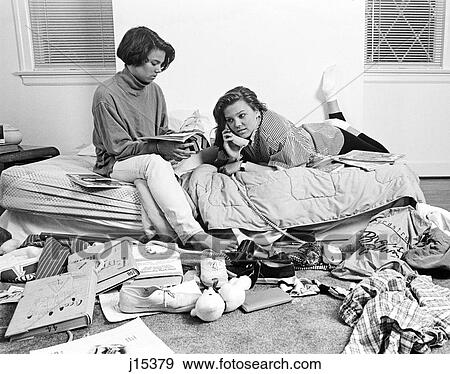 1980S Two Teenage African American Girls In Cluttered Bedroom One Talking On The Phone One Reading Magazine View Large Photo Image Stock Photo - 1980S Two Teenage African American Girls In Cluttered Bedroom One Talking On The Phone One Reading Magazine. Fotosearch