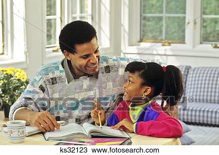 1990s AFRICAN AMERICAN FATHER HELPING DAUGHTER WITH HER HOMEWORK View Large Photo Image Stock Image - 1990s AFRICAN AMERICAN FATHER HELPING DAUGHTER WITH HER HOMEWORK. Fotosearch