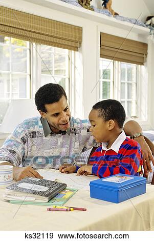 1990s AFRICAN AMERICAN FATHER HELPING SON WITH HOMEWORK View Large Photo Image Stock Photo - 1990s AFRICAN AMERICAN FATHER HELPING SON WITH HOMEWORK. Fotosearch