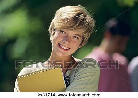 1990s COLLEGE STUDENT WITH BOOKS SMILING LOOKING AT CAMERA View Large Photo Image Picture - 1990s COLLEGE STUDENT WITH BOOKS SMILING LOOKING AT CAMERA. Fotosearch