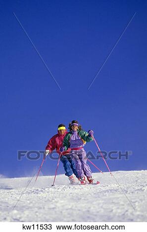 1990S Couple Skiing Down Slope Dressed Colorful Pastels View Large Photo Image Stock Image - 1990S Couple Skiing Down Slope Dressed Colorful Pastels. Fotosearch