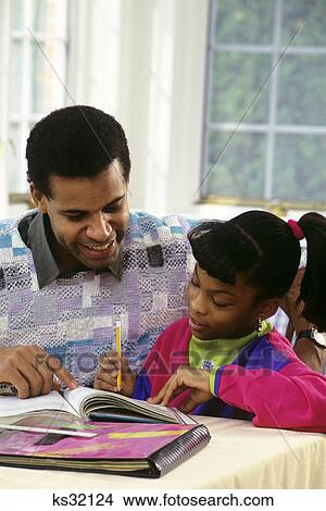 1990s FATHER HELPING DAUGHTER WITH HER HOMEWORK View Large Photo Image Picture - 1990s FATHER HELPING DAUGHTER WITH HER HOMEWORK. Fotosearch